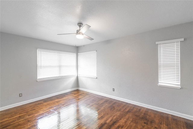 unfurnished room featuring ceiling fan, dark hardwood / wood-style flooring, and a textured ceiling