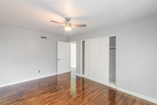 unfurnished bedroom featuring ceiling fan, a closet, and dark hardwood / wood-style floors