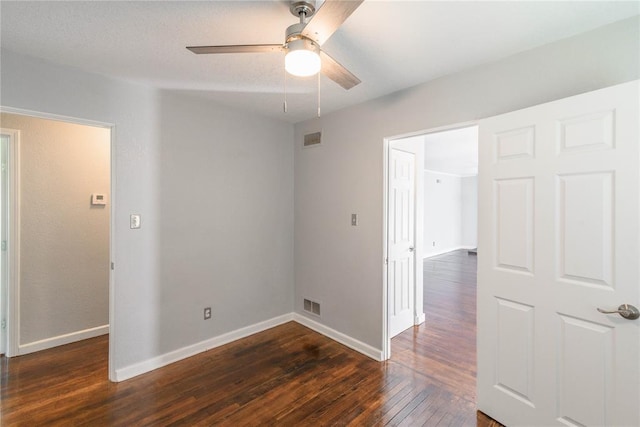 unfurnished room featuring dark hardwood / wood-style floors and ceiling fan