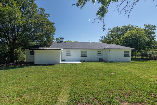 back of house featuring a lawn, central air condition unit, and a patio