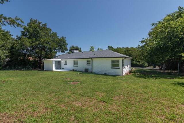 back of property featuring a lawn