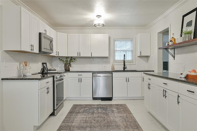 kitchen with decorative backsplash, sink, white cabinets, and stainless steel appliances