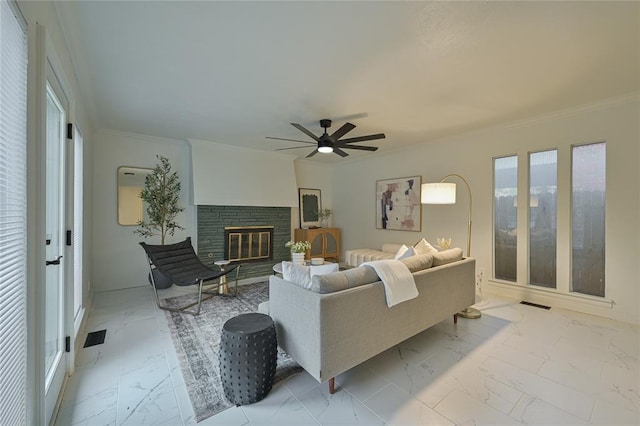 living room with ceiling fan and ornamental molding