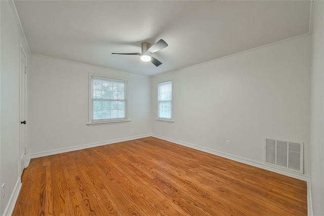 unfurnished room featuring ceiling fan, light hardwood / wood-style floors, and crown molding