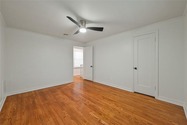 spare room featuring ceiling fan, light hardwood / wood-style flooring, and crown molding