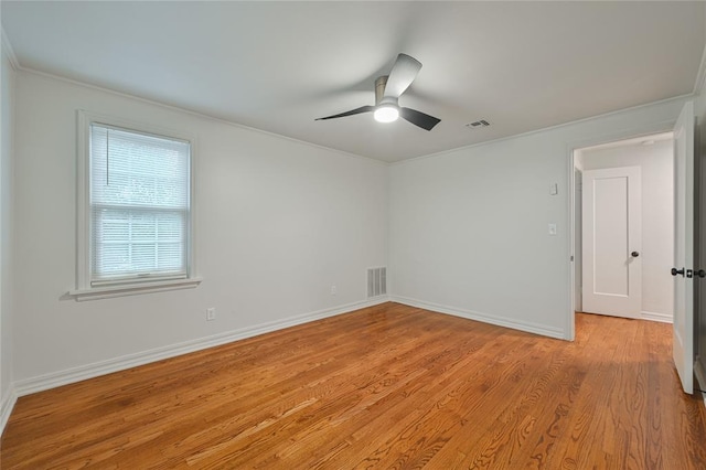 spare room with ceiling fan, light hardwood / wood-style flooring, and crown molding