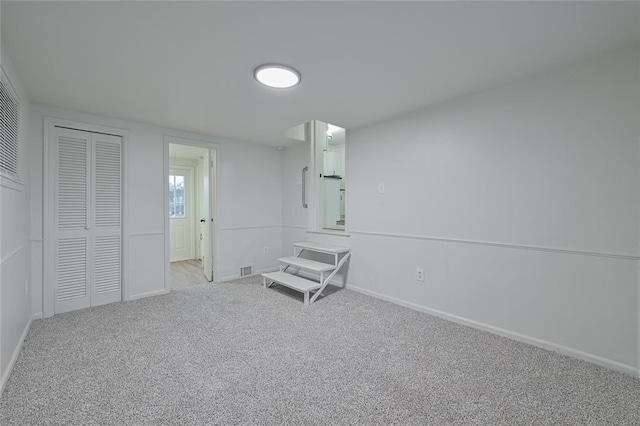 unfurnished bedroom featuring light colored carpet and a closet