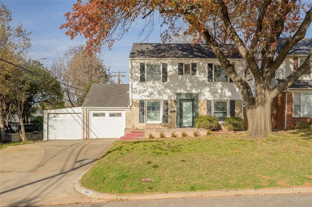 colonial home with a front yard and a garage