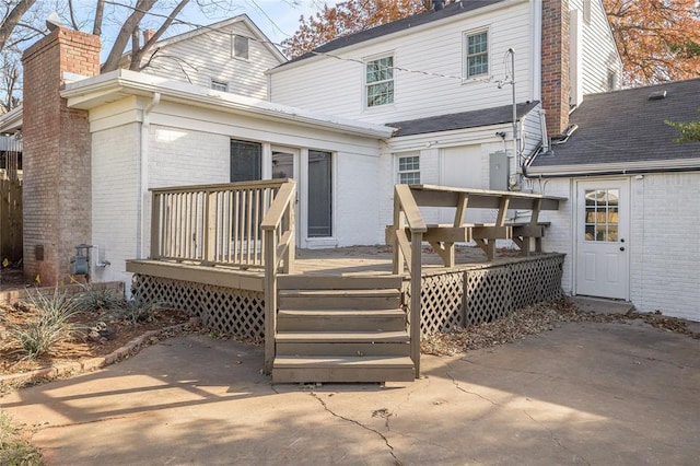 back of property with a wooden deck