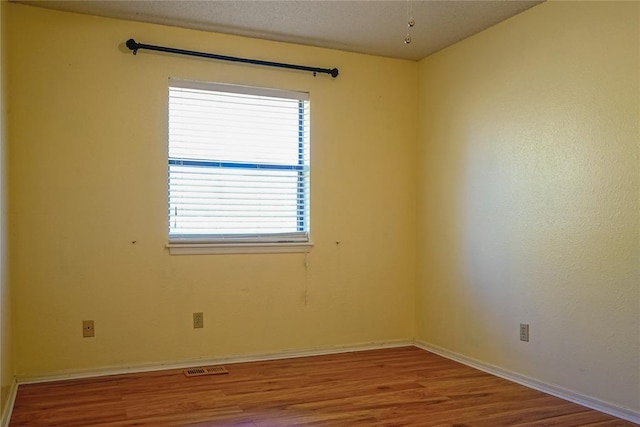 empty room with wood-type flooring