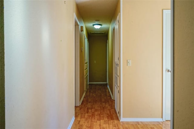 hall with light wood-type flooring