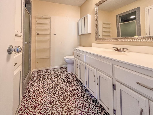 bathroom with vanity, toilet, and an enclosed shower