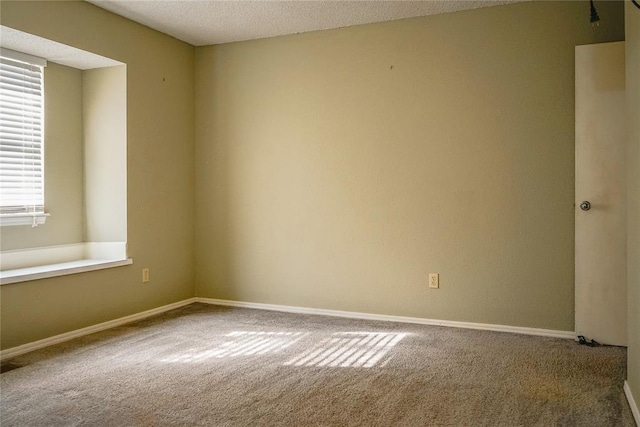 carpeted empty room with a textured ceiling