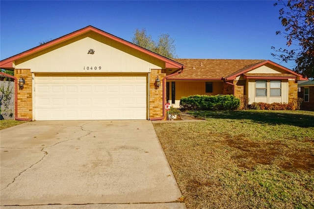 ranch-style home with a garage and a front lawn