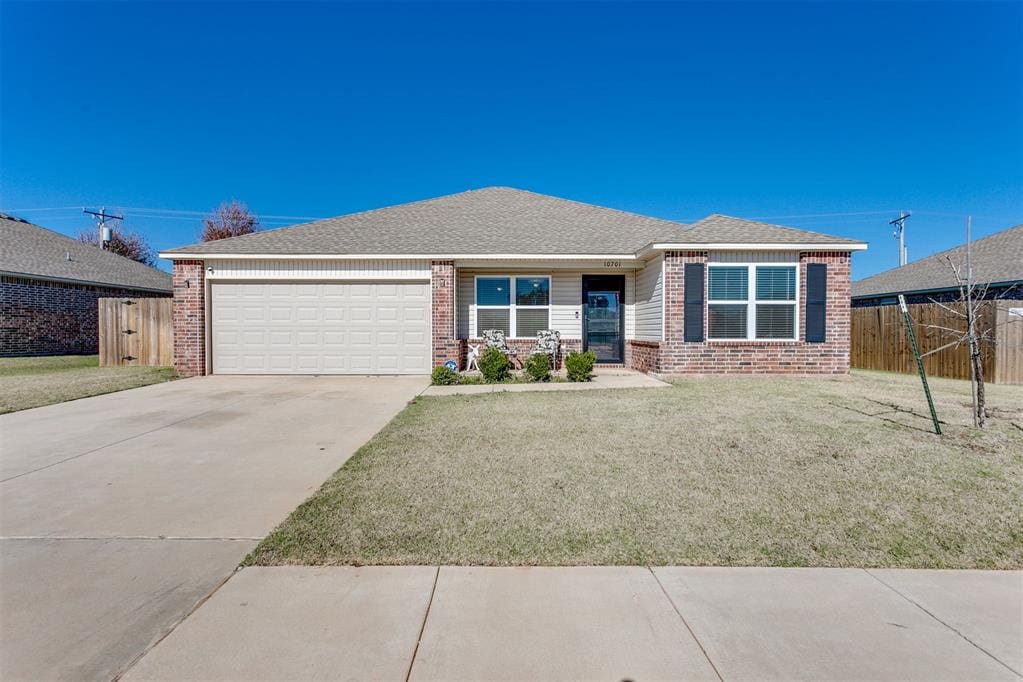 view of front of home featuring a garage and a front lawn