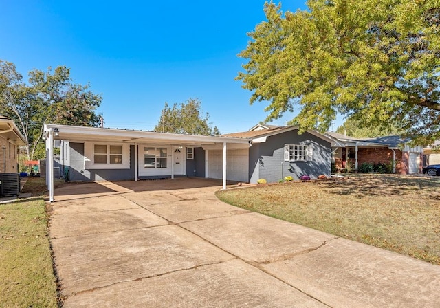 ranch-style house featuring a carport, cooling unit, and a front yard