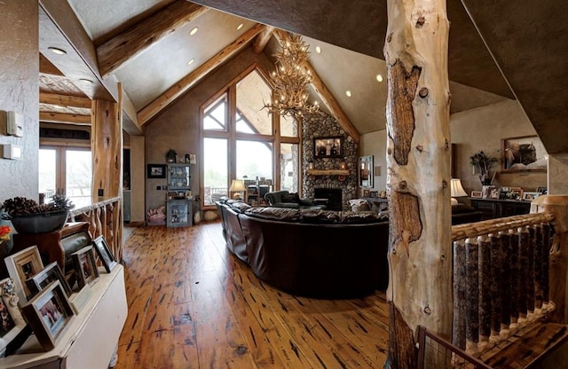 living room with a fireplace, hardwood / wood-style flooring, plenty of natural light, and beamed ceiling