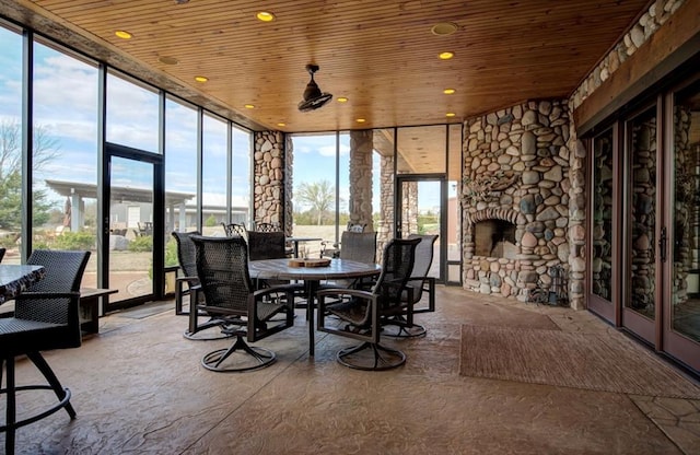 sunroom / solarium with wooden ceiling, a fireplace, and a healthy amount of sunlight