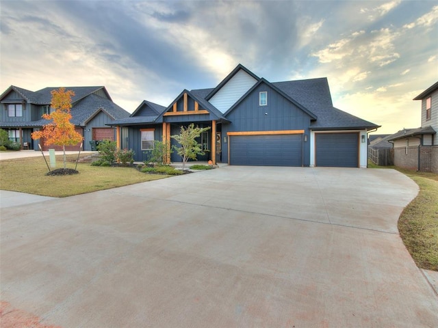 view of front of property featuring a yard and a garage