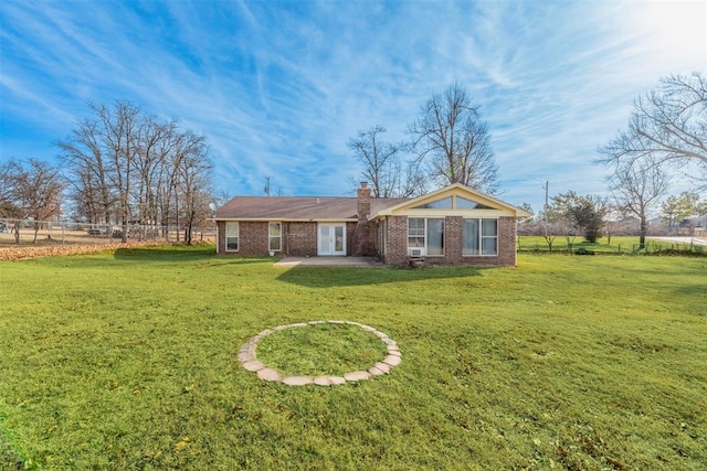 back of house with a patio area and a lawn