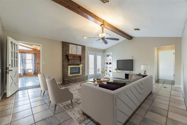 tiled living room featuring french doors, a brick fireplace, a textured ceiling, and vaulted ceiling with beams