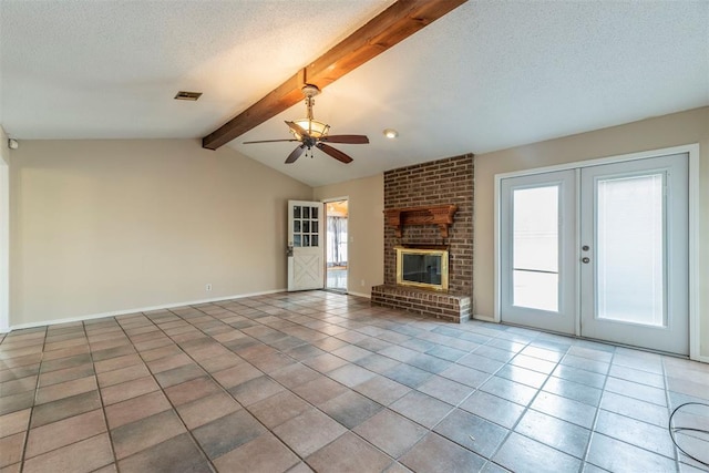 unfurnished living room with tile patterned floors, a fireplace, lofted ceiling with beams, and a textured ceiling