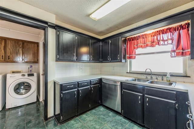 laundry area with washer / dryer, sink, cabinets, dark tile patterned floors, and a textured ceiling