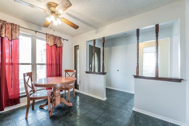 dining space with ceiling fan and a textured ceiling