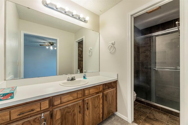 bathroom featuring vanity, ceiling fan, toilet, and walk in shower