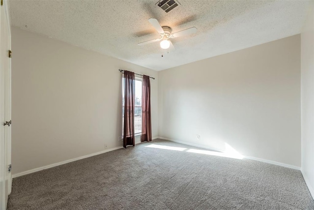 spare room with carpet floors, a textured ceiling, and ceiling fan