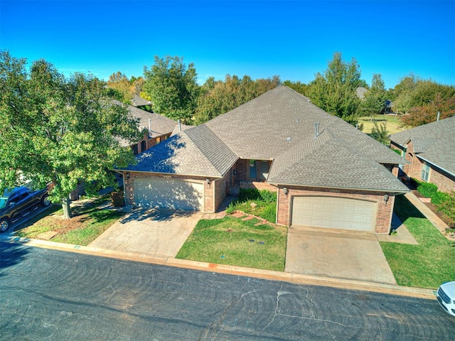 view of front of home with a garage and a front lawn