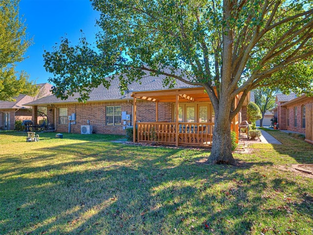 back of property featuring a yard and a deck