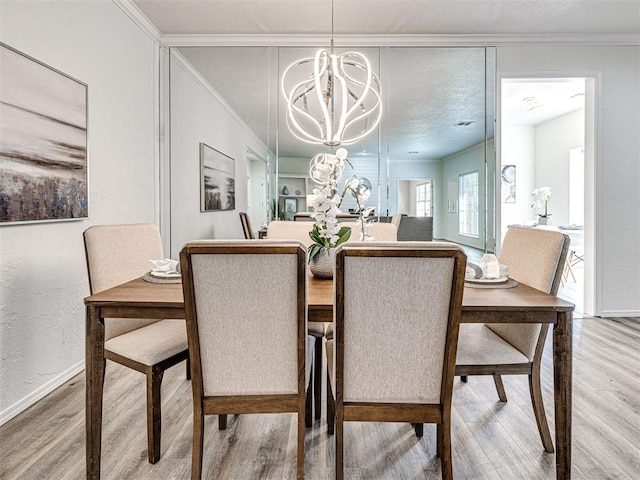 dining space featuring hardwood / wood-style floors, ornamental molding, and a notable chandelier