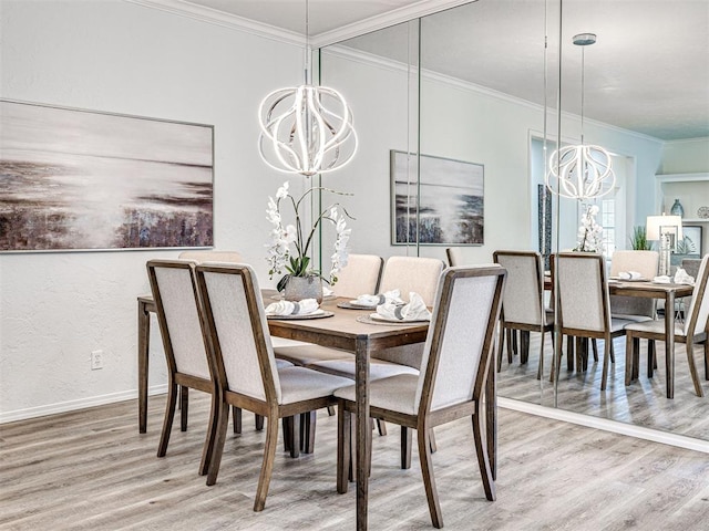 dining room with hardwood / wood-style floors, ornamental molding, and an inviting chandelier