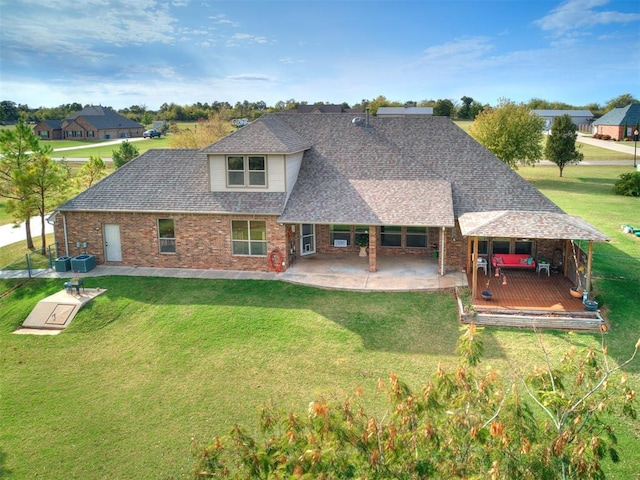 rear view of house featuring a patio area and a lawn