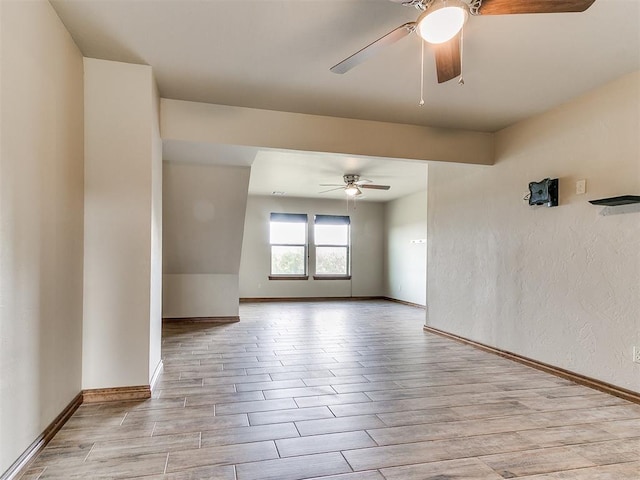 unfurnished room with ceiling fan and light wood-type flooring