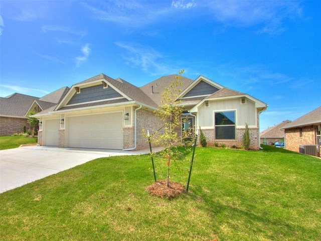 craftsman-style home with a front yard, a garage, and central AC unit