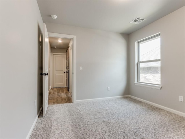 unfurnished room featuring light colored carpet