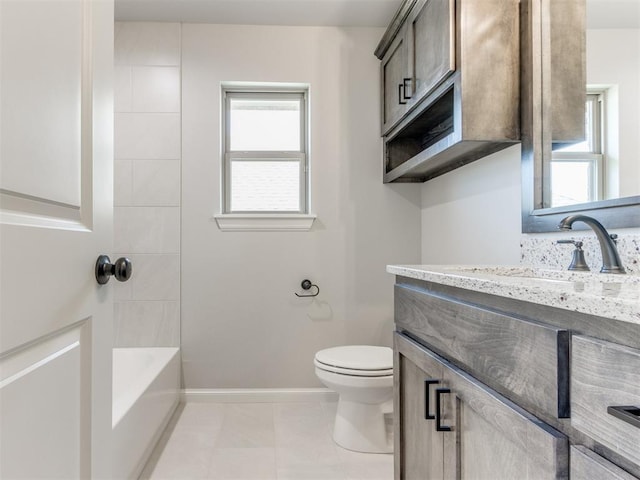 full bathroom featuring tile patterned flooring, vanity, toilet, and tiled shower / bath combo