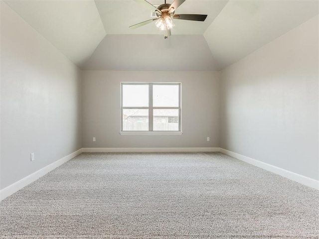 carpeted empty room with ceiling fan and vaulted ceiling