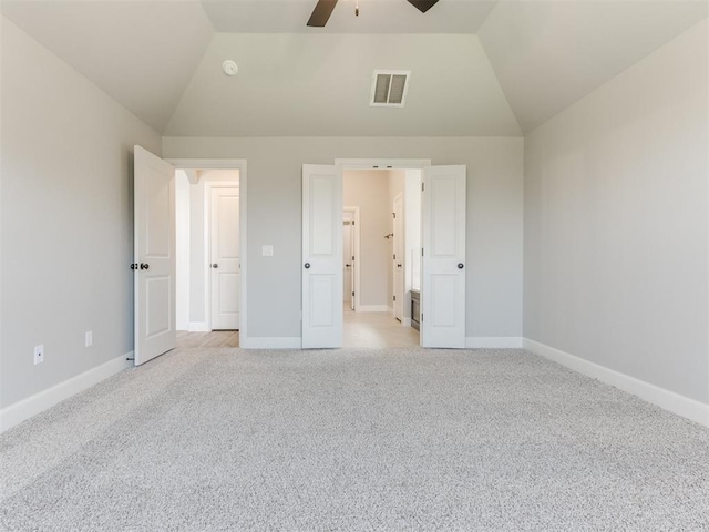 unfurnished bedroom featuring light colored carpet, ceiling fan, and lofted ceiling