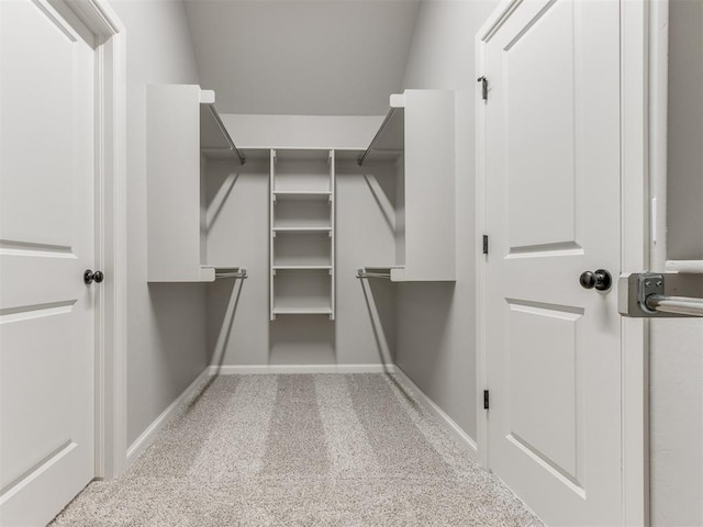 spacious closet with carpet flooring and lofted ceiling