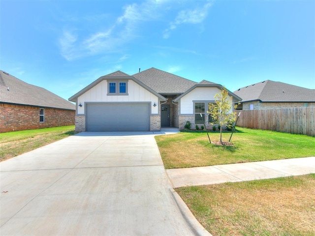 view of front of house featuring a garage and a front lawn