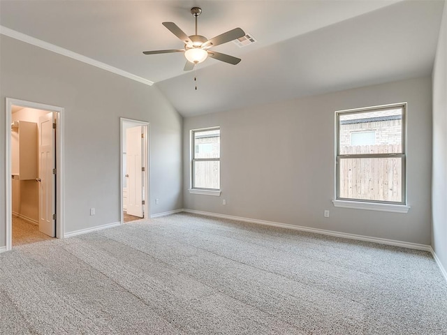 unfurnished bedroom with light carpet, vaulted ceiling, and ceiling fan