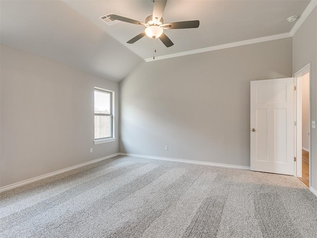 carpeted spare room featuring ceiling fan, lofted ceiling, and crown molding