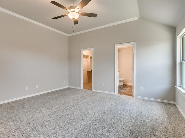 unfurnished bedroom featuring ensuite bath, a spacious closet, ceiling fan, carpet floors, and a closet