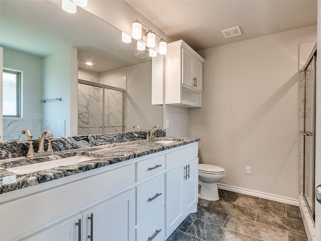 bathroom with vanity, toilet, and an enclosed shower