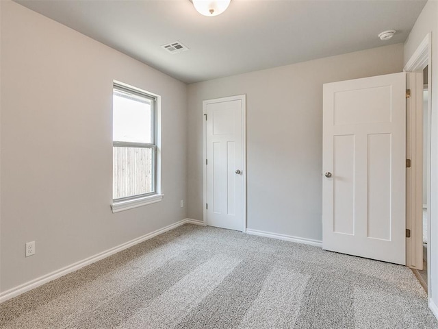 empty room featuring light colored carpet