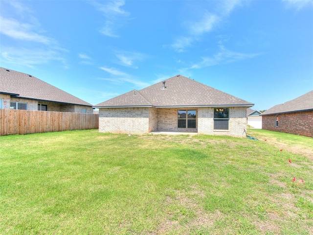 back of house featuring a yard