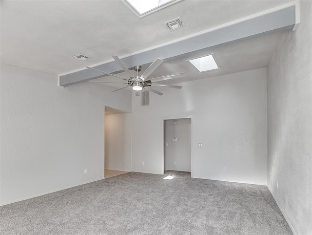 carpeted empty room with a skylight and ceiling fan